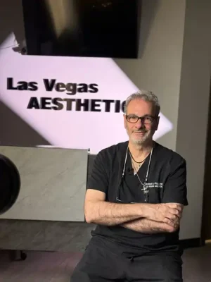 Thomas S. Pulice, PA-C, owner and sole provider of Las Vegas Aesthetics, seated in front of the Las Vegas Aesthetics clinic sign